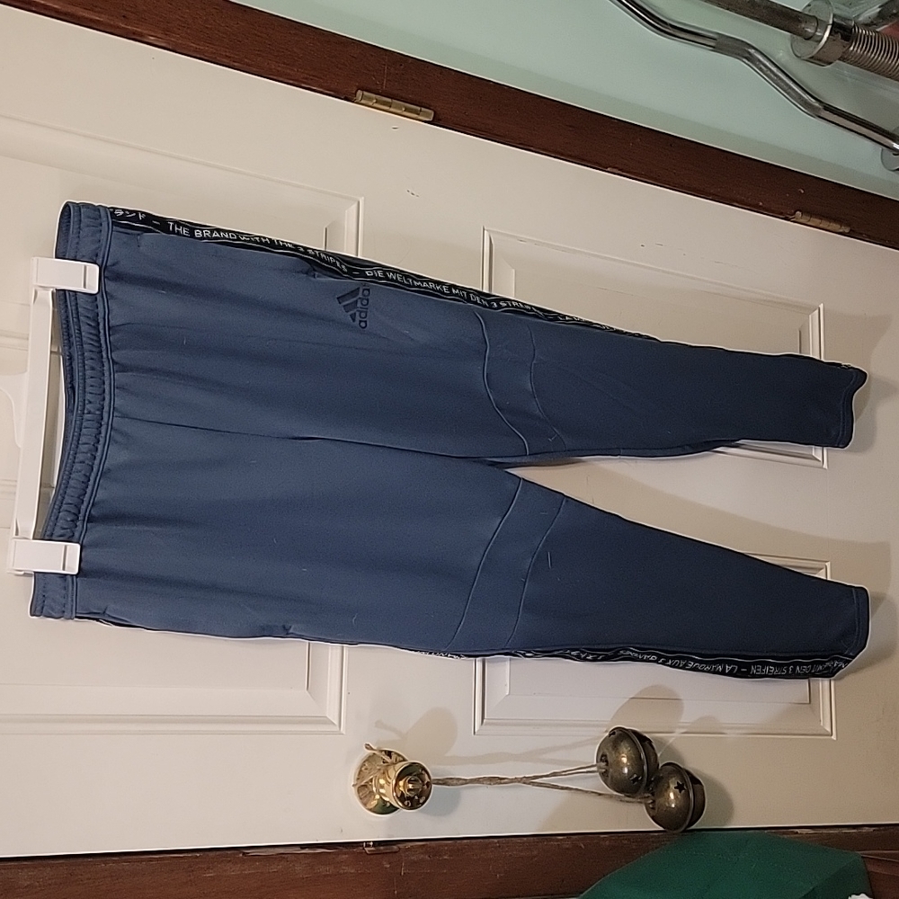 Mens blue Adidas sweat pants zipper pockets and zipper at leg cuff